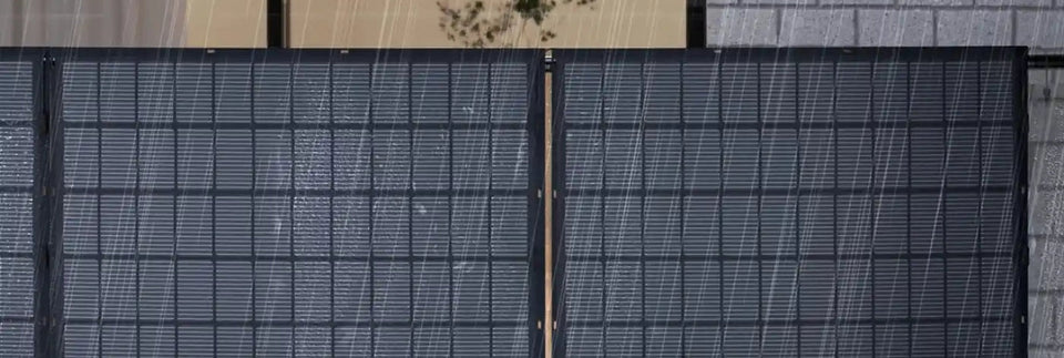 Flexible RENEPV-Solarmodule an einem Balkongeländer vor einer Hauswand bei Regen.
