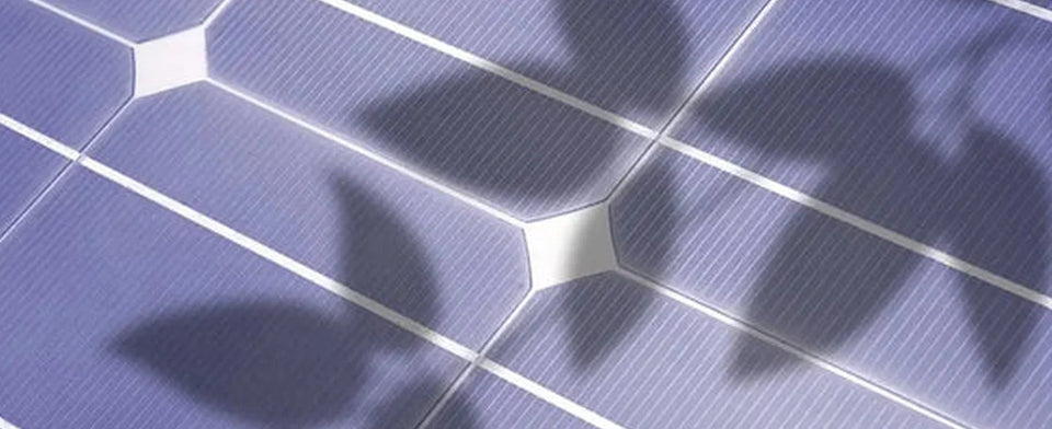 Schatten fallen auf die Zellen eines Photovoltaikmoduls.